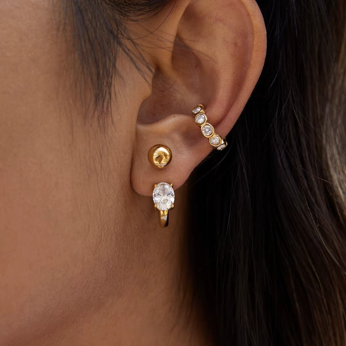 Nomad ear cuff shown close up on the ear from a slightly different angle, highlighting the row of bezel-set round crystals.