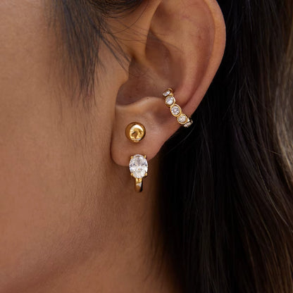 Nomad ear cuff shown close up on the ear from a slightly different angle, highlighting the row of bezel-set round crystals.