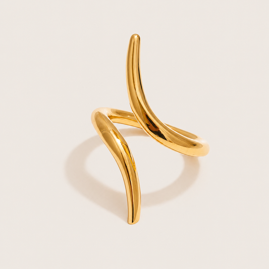 Gold ring with two curved, thorn-like open pieces crossing in an asymmetric sculptural shape — Folie à Trois Obsidian RING.