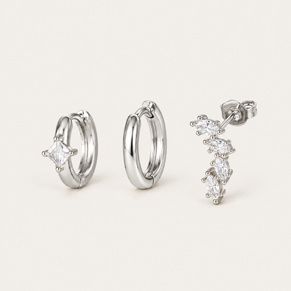 The Folie à Trois Odile SET in silver: a plain hoop, a hoop set with a square crystal, and a marquise climber stud.
