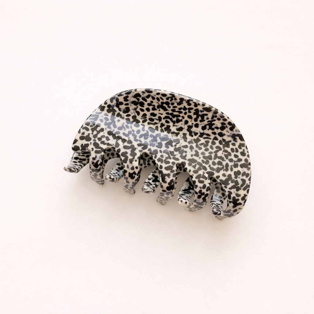 A single grey leopard print acetate hair claw clip shown on a plain background.