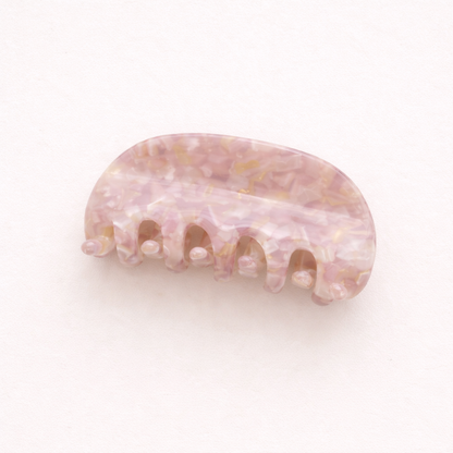 A single lavender and pearl speckled acetate hair claw clip shown on a plain background.