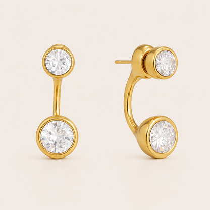 Gold ear-jacket stud earring with two round bezel-set white zirconia stones linked by a slender bar — Folie à Trois Ondine EARRINGS.
