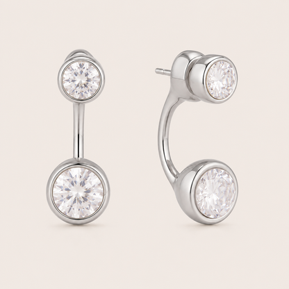 Silver ear-jacket stud earring with two round bezel-set white zirconia stones linked by a slender bar — Folie à Trois Ondine EARRINGS.