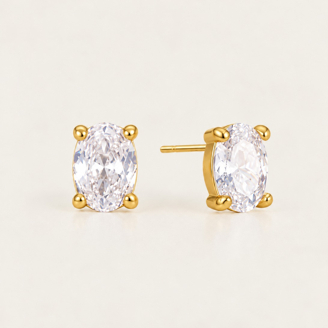 Gold Ovalie EARRINGS: oval-cut white zirconia studs in a four-prong gold setting — Folie à Trois wholesale jewelry