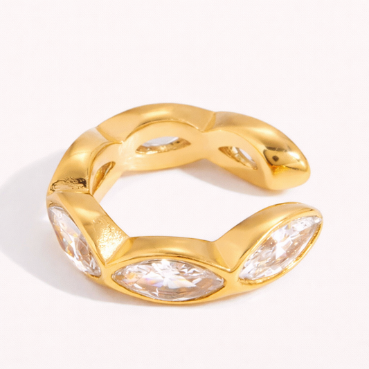 Gold Overdrive ear cuff in an open C-shape, set with three marquise crystals along a faceted textured band.