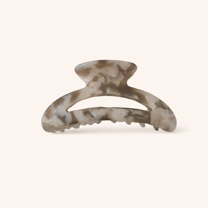 Grey and taupe marbled acetate arched claw clip from the Palm Springs HAIR CLIP collection, on a cream background.
