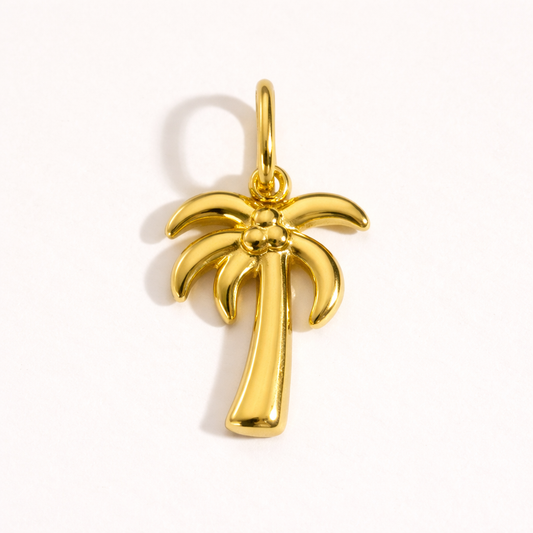 The Palm Tree CHARM in polished gold, its curved fronds and beaded coconuts shown alone on a plain white studio background.