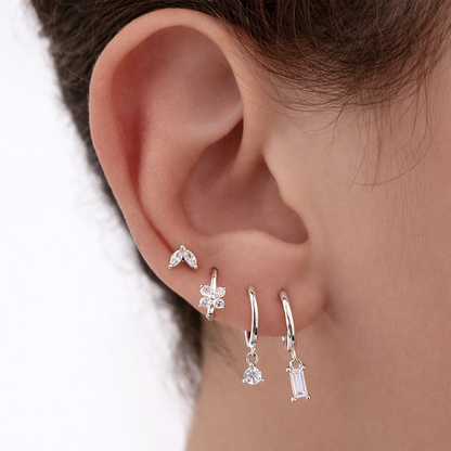 Worn layered along the ear, Perfect Earparty SET shows its four silver pieces catching the light together.