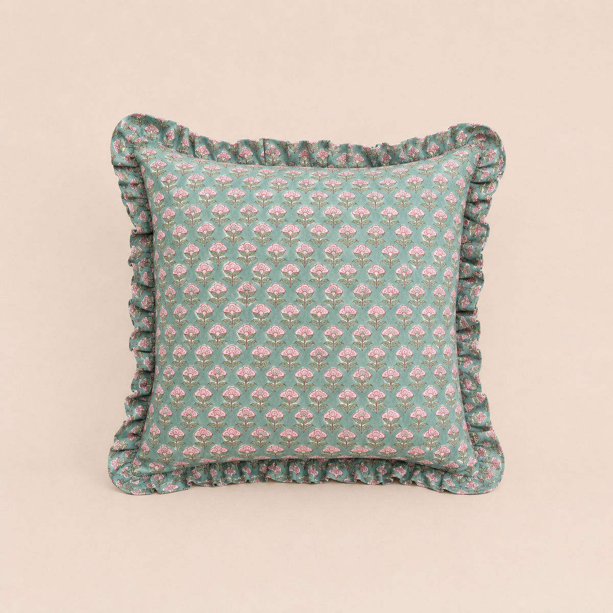 Sage green square cushion with a repeating pink floral bud print and ruffled trim, the Pipli Green Square Cushion on a neutral background.