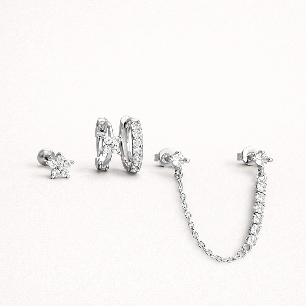 Pixie Set in silver tone, showing the same flower stud, pave huggie hoop, and chain-linked stud pair.