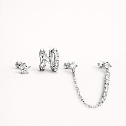 Pixie Set in silver tone, showing the same flower stud, pave huggie hoop, and chain-linked stud pair.