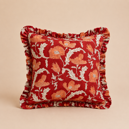 Poppy Flame Square cushion in deep red with a bold orange poppy floral print and cream leaf outlines, finished with a ruffled edge.