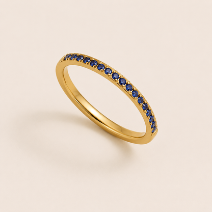 Gold pavé ring set with sparkling blue cubic zirconia stones on a cream backdrop — Folie à Trois Prisma RING wholesale stacking ring