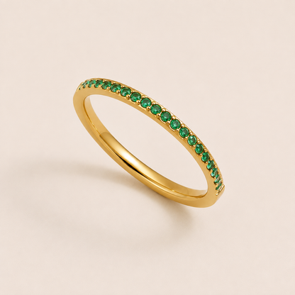 Gold pavé ring set with sparkling green cubic zirconia stones on a cream backdrop — Folie à Trois Prisma RING wholesale stacking ring