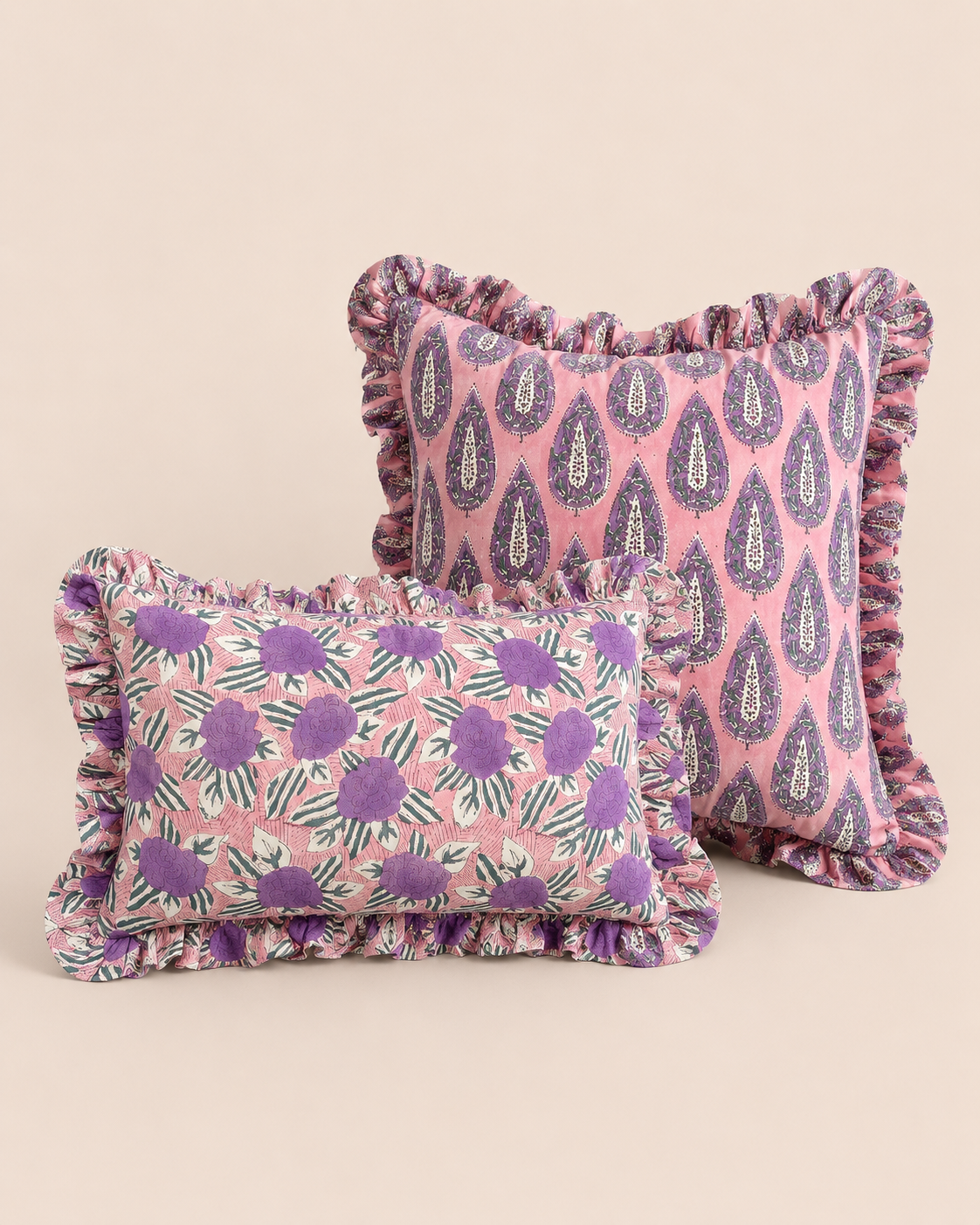 Purple Garden Cushion SET pairing a pink paisley teardrop square cushion with a smaller purple floral rectangle cushion, both ruffle-trimmed.