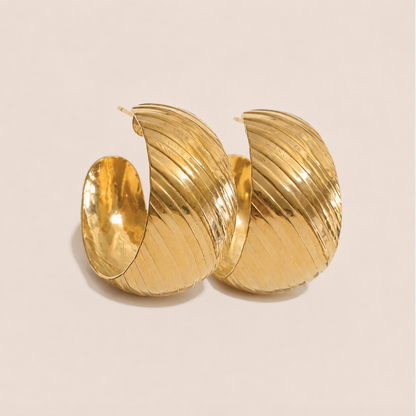 Chunky gold hoop earring with a ribbed, twisted texture and glossy finish — Folie à Trois Rally EARRINGS.