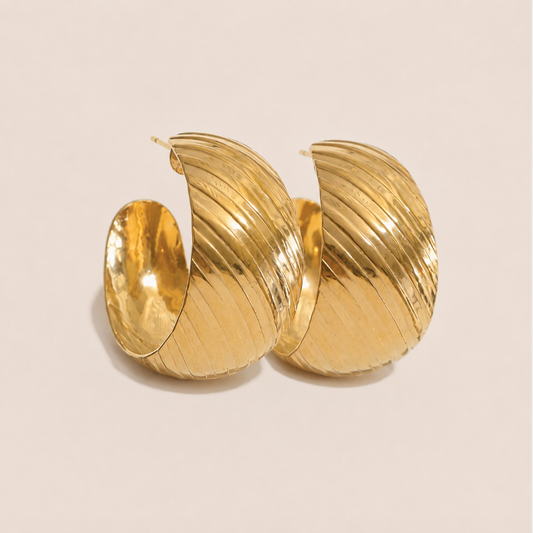 Chunky gold hoop earring with a ribbed, twisted texture and glossy finish — Folie à Trois Rally EARRINGS.