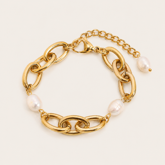 Reckless BRACELET in gold with bold chunky oval links and two large baroque pearls set between the chain sections, shown flat.