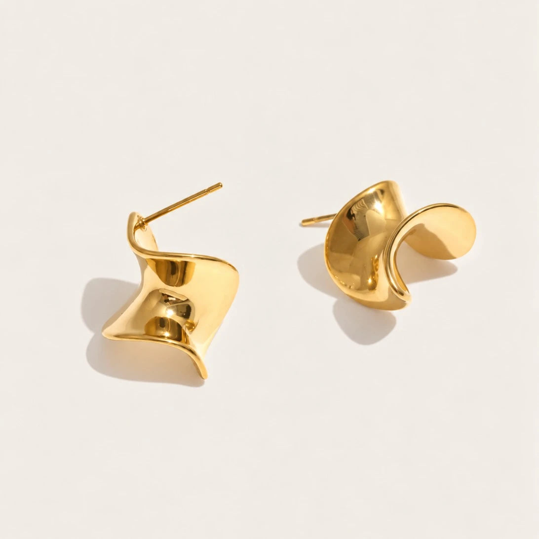 Gold Ribbon EARRINGS: a pair of small studs shaped like a twisted, wavy ribbon bow — Folie à Trois