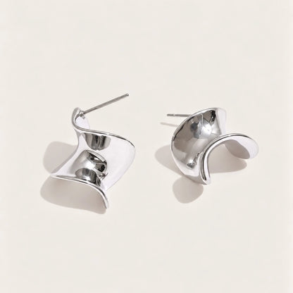 Silver-tone Ribbon EARRINGS: a pair of small studs shaped like a twisted, wavy ribbon bow — Folie à Trois