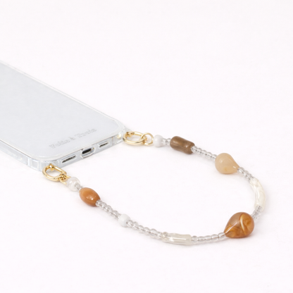 Mixed stone teardrop beaded Romee short phone strap clipped to a clear phone case, close-up view.