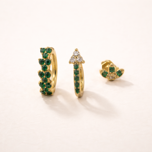 Rosalia Set of gold jewelry, a pave hoop, a hoop with a crystal-topped point, and a flower stud, all set with green stones.