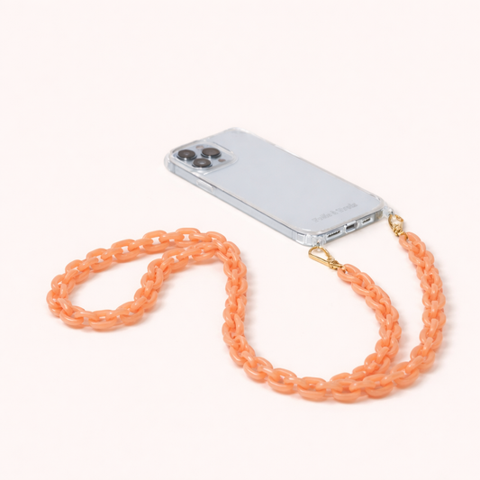 Route Long Phone Chain in a peach acrylic chunky chain, clipped to a clear phone case with gold hardware.