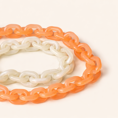 Route Long Phone Chain close-up showing the chunky acrylic links in both peach and cream colorways.