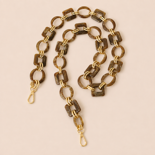 Dark brown tortoiseshell acrylic link phone chain with gold connectors coiled on cream — Folie à Trois Rowan wholesale phone chain