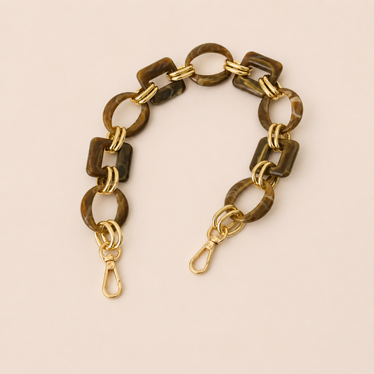 Short dark brown tortoiseshell acrylic link phone chain with gold connectors on cream — Folie à Trois Rowan wholesale phone chain