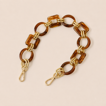 Short amber tortoiseshell acrylic link phone chain with gold connectors on cream — Folie à Trois Rowan wholesale phone chain