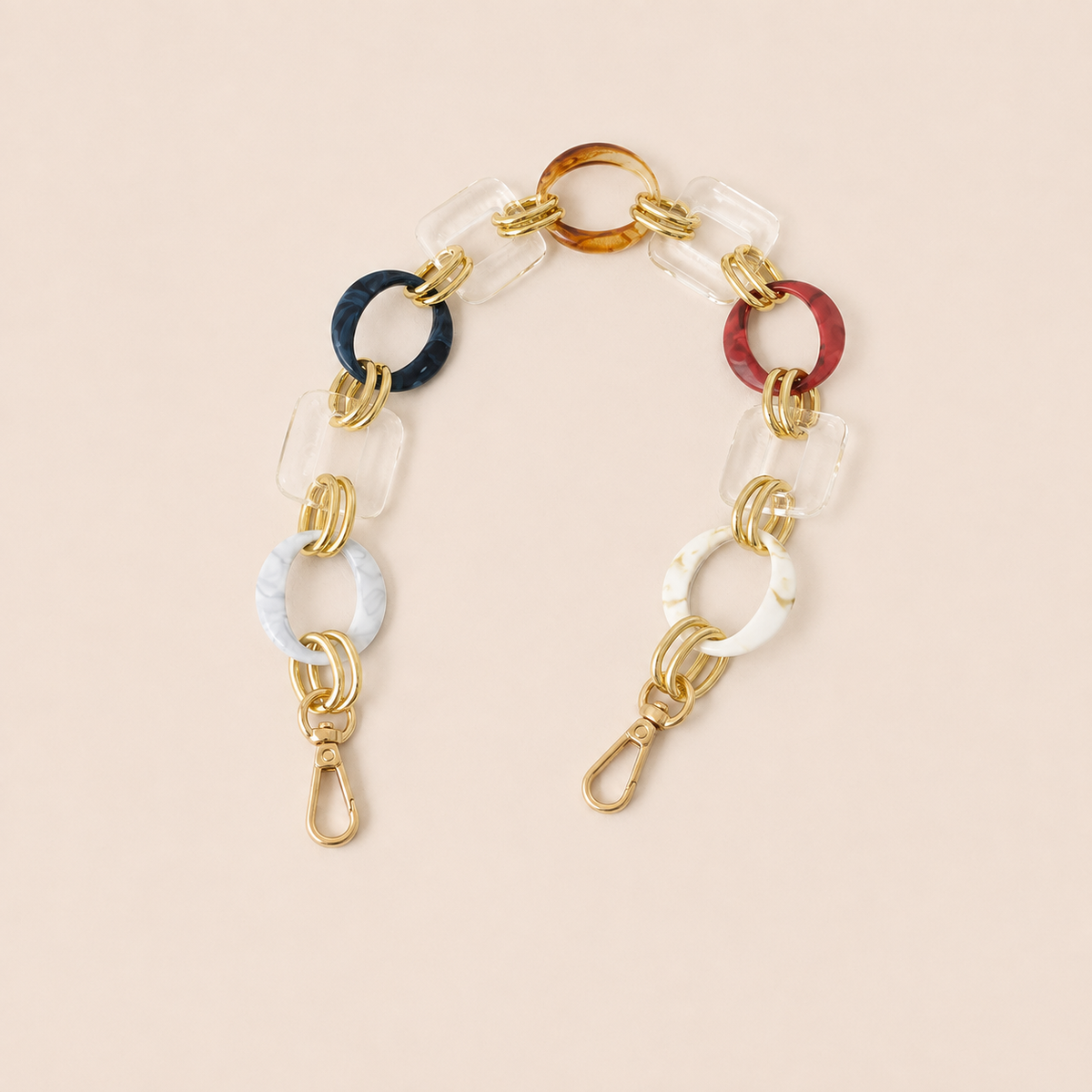 Short multicolor acrylic ring-link phone chain in navy, rust, white, and clear with gold connectors — Folie à Trois Rowan wholesale phone chain