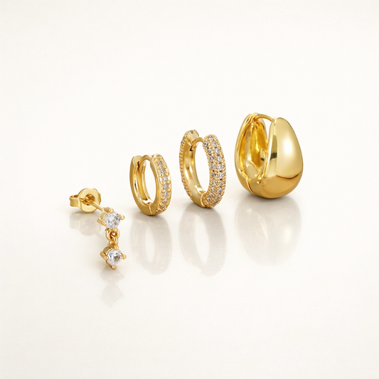 Roxy Set in gold, a dangling crystal drop stud, a plain hoop, a pave hoop, and a chunky teardrop hoop.