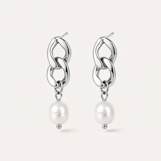 Rule Earrings link two chunky silver curb-chain loops that drop into a smooth freshwater pearl at the base.