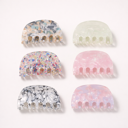 Ruth HAIR CLIP six half-moon claw clips in confetti, mint, pink pearl, lilac pearl, marble and multicolor patterns, studio grid.