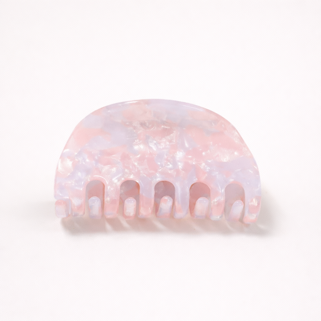 Ruth HAIR CLIP half-moon acetate claw clip in a pink and lilac pearl marbled pattern, studio shot.