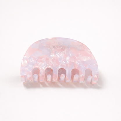 Ruth HAIR CLIP half-moon acetate claw clip in a pink and lilac pearl marbled pattern, studio shot.
