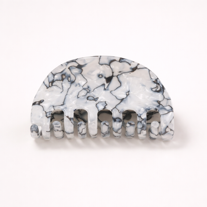 Ruth HAIR CLIP half-moon acetate claw clip in a black and white marbled pattern, studio shot.