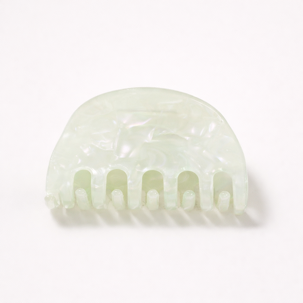 Ruth HAIR CLIP half-moon acetate claw clip in a mint green pearl shade, studio shot.