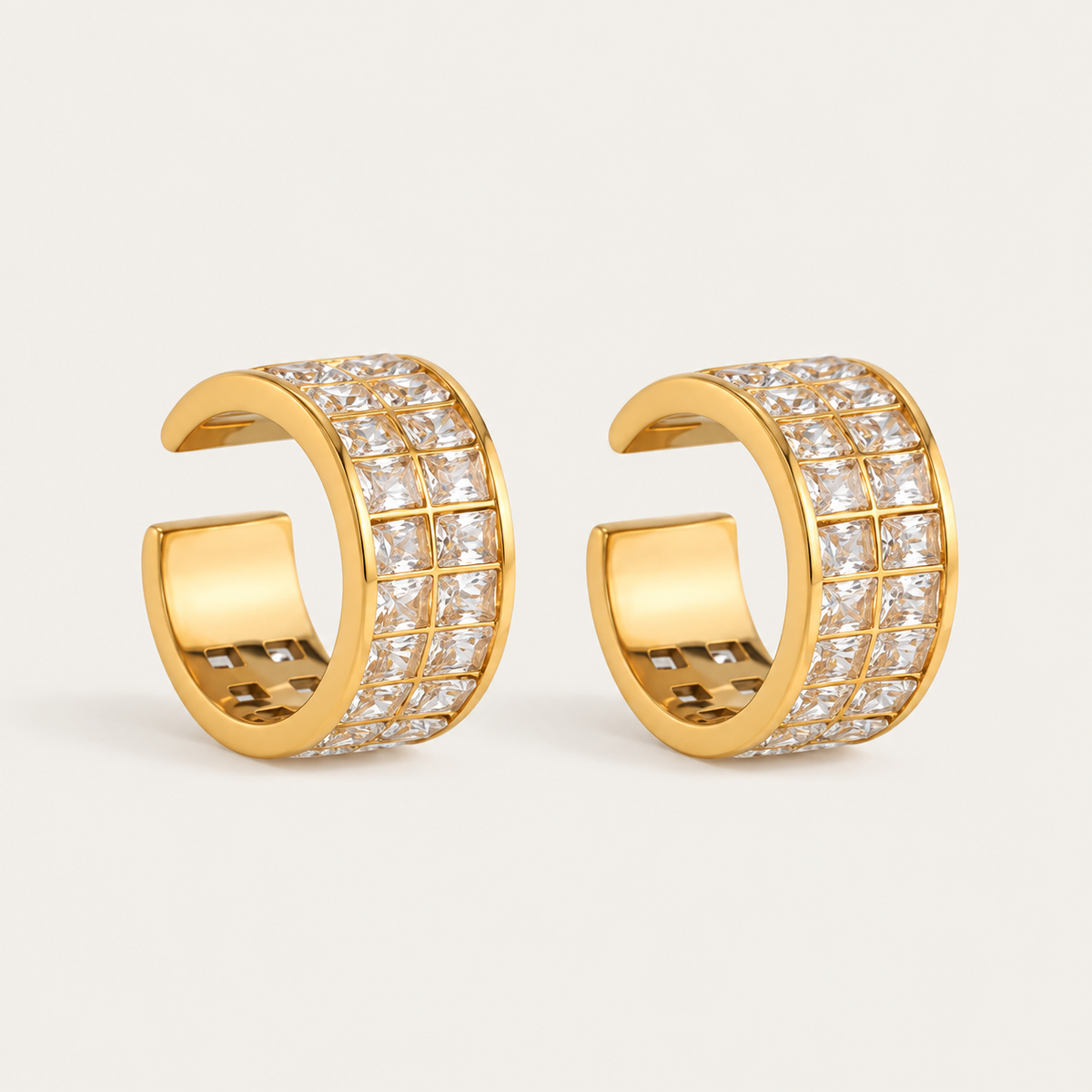 Pair of gold ear cuffs edged with a pavé crystal grid, product shot for the Folie à Trois Sabine EAR CUFF.