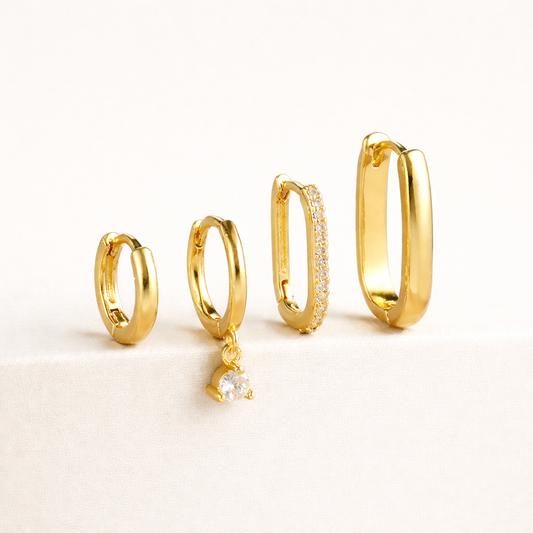 The Sabrina SET is four gold hoops of graduating sizes, one pave-lined and one with a clear crystal charm.