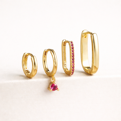 The Sabrina SET is shown in a pink crystal colorway, with pave and dangling stones on two of the four gold hoops.