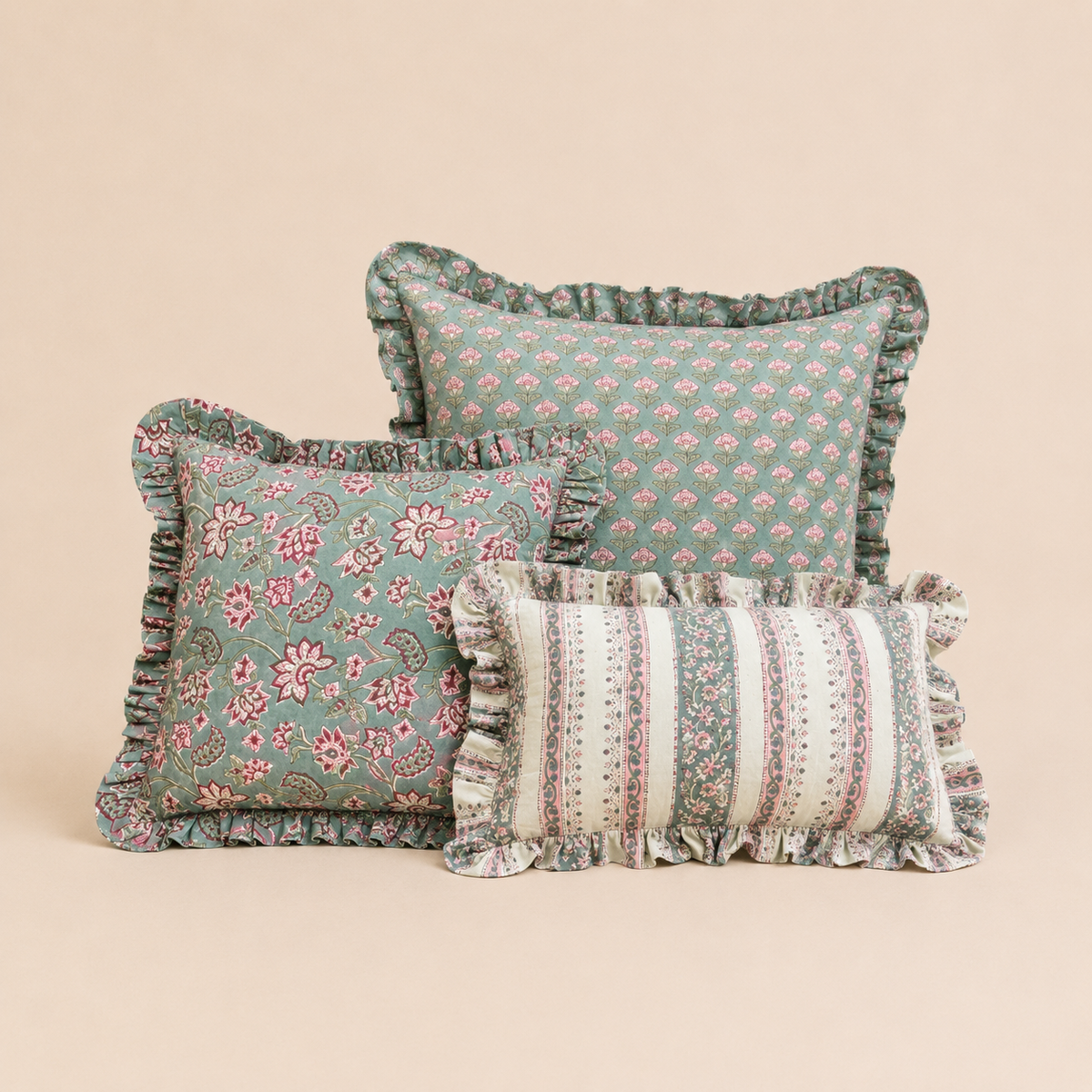 Teal square cushion with a repeating droplet peacock-feather print in rust and cream, finished with a ruffled edge, Vive cushion collection.