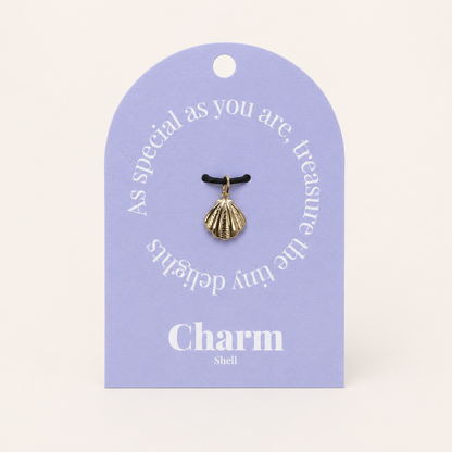 The Shell CHARM displayed on a lavender Charm gift tag, hanging from a black cord against the card text As special as you are.
