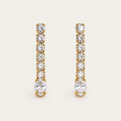 Gold linear drop earring with graduated round zirconia stones ending in a marquise-cut stone — Folie à Trois Shimmer EARRINGS.