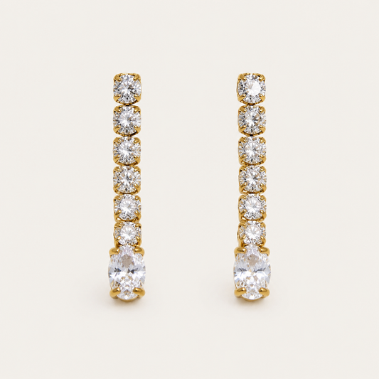 Gold linear drop earring with graduated round zirconia stones ending in a marquise-cut stone — Folie à Trois Shimmer EARRINGS.