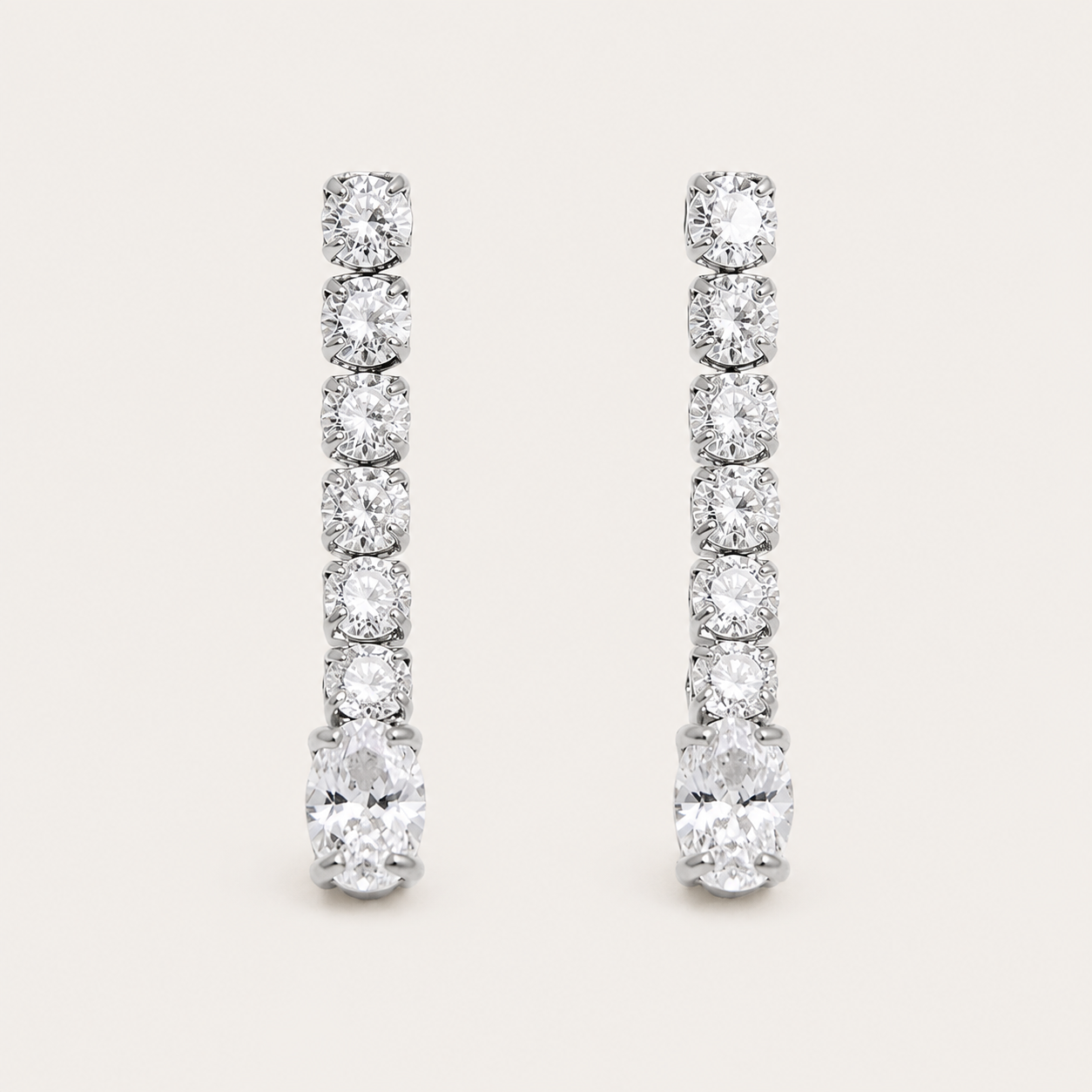 Silver linear drop earring with graduated round zirconia stones ending in a marquise-cut stone — Folie à Trois Shimmer EARRINGS.