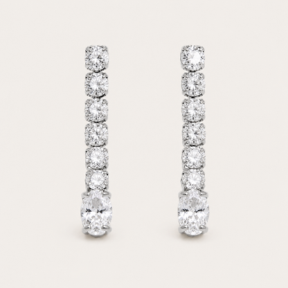 Silver linear drop earring with graduated round zirconia stones ending in a marquise-cut stone — Folie à Trois Shimmer EARRINGS.