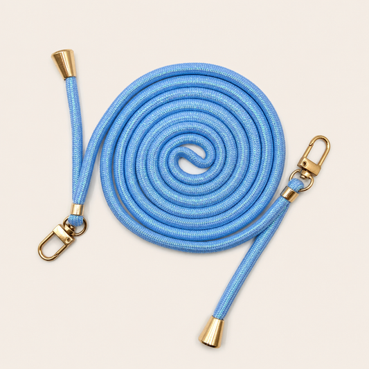 Blue Shimmery PHONE CORD with a metallic sheen, coiled with gold hardware, shown as a flat lay.